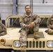 U.S. Army soldiers pose with their HMMWV during a static display