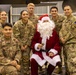 U.S. Army Soldiers pose with Santa During a community outreach in Powidz Poland