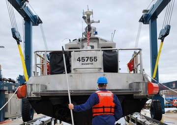 Station Manistee lifts the small boat