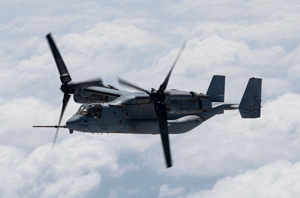 Two KC-130J Super Hercules conduct TAAR with MV-22 Ospreys within HOA