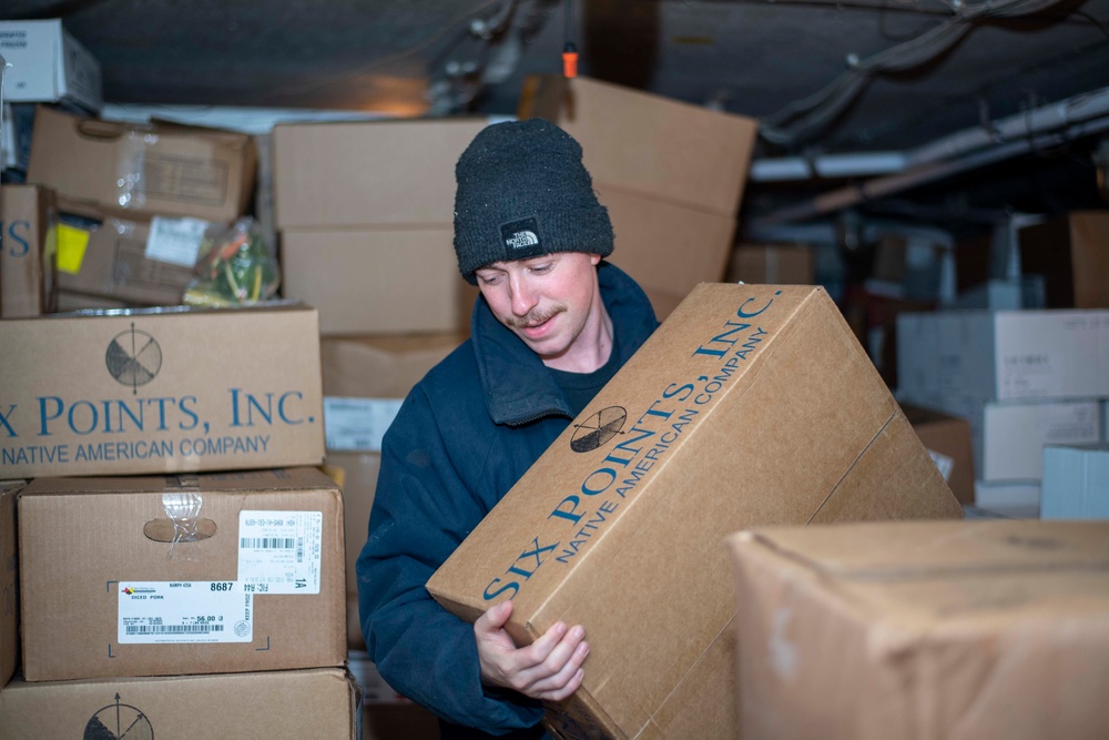 U.S. Navy Sailor Moves Frozen Goods