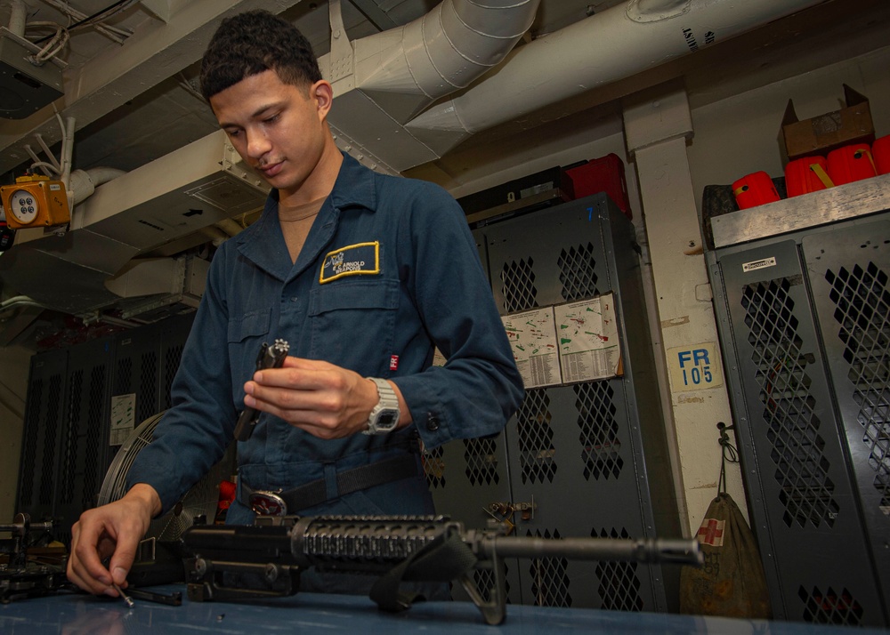 Sailor Disassembles Rifle