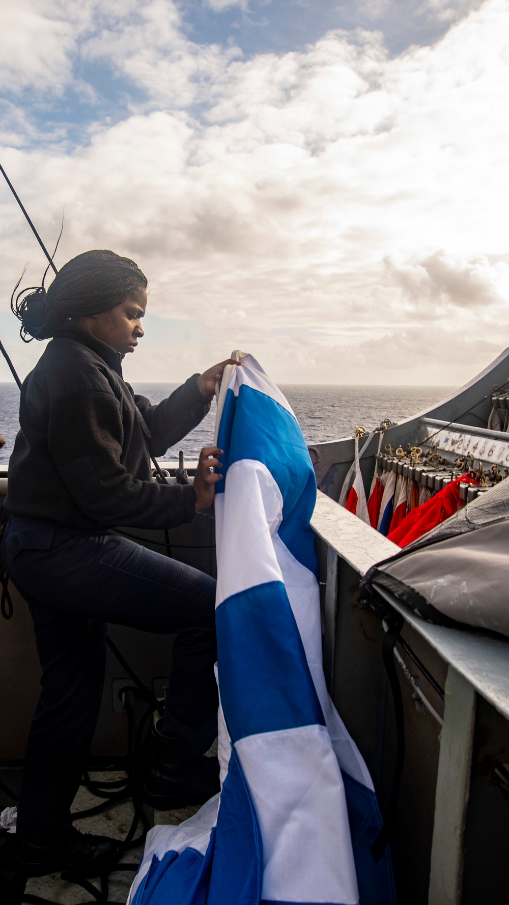 Sailor Stows Signal Flag