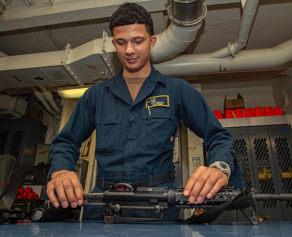 Sailor Disassembles Rifle