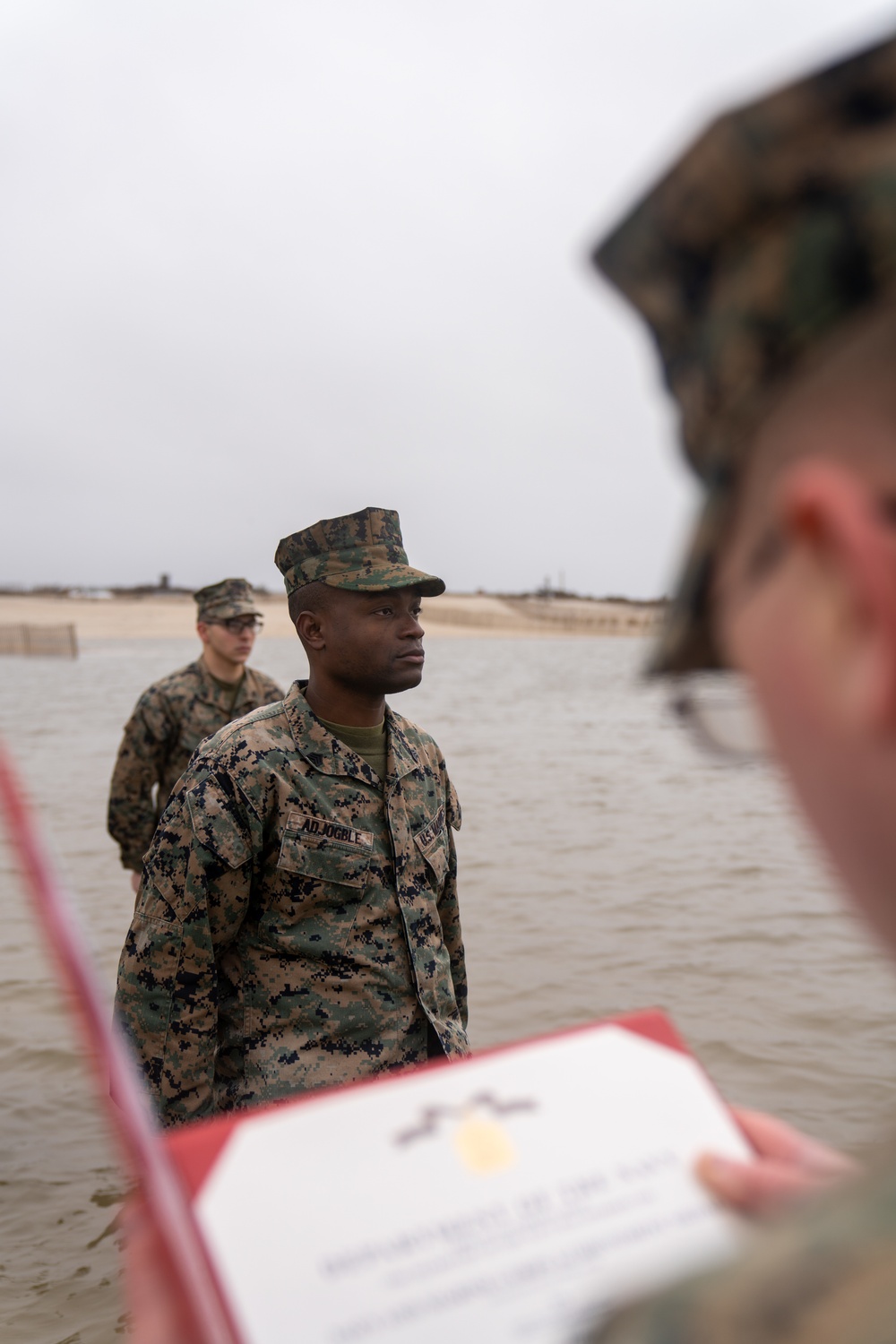 First Marine Corps District awards, reenlists Sgt. Kokou D. Adjogble