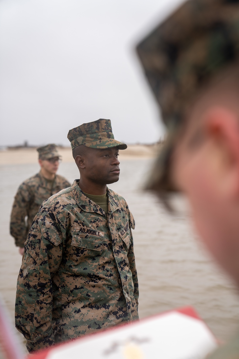 First Marine Corps District awards, reenlists Sgt. Kokou D. Adjogble