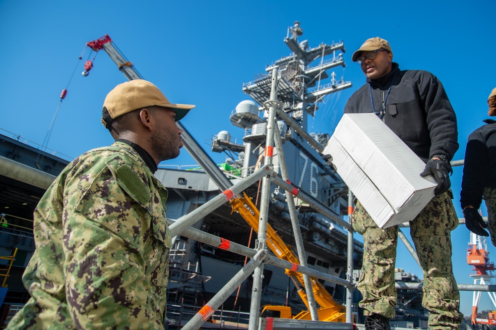 USS Ronald Reagan (CVN 76) Sailors transport cargo