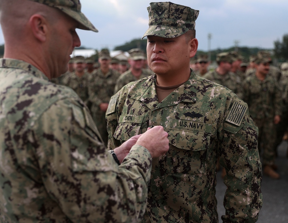 Promotion of Lt. Commander Chen to the rank of Commander.