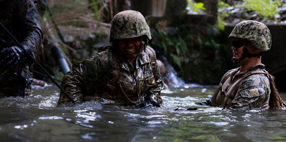 Utilitiesman Constructionman Angelina Cotten, passes through cold waters during the E-course.