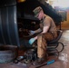 Construction Mechanic 3rd Class Scott Lyons maintains a piece of Civil Engineering Support Equipment (CESE).