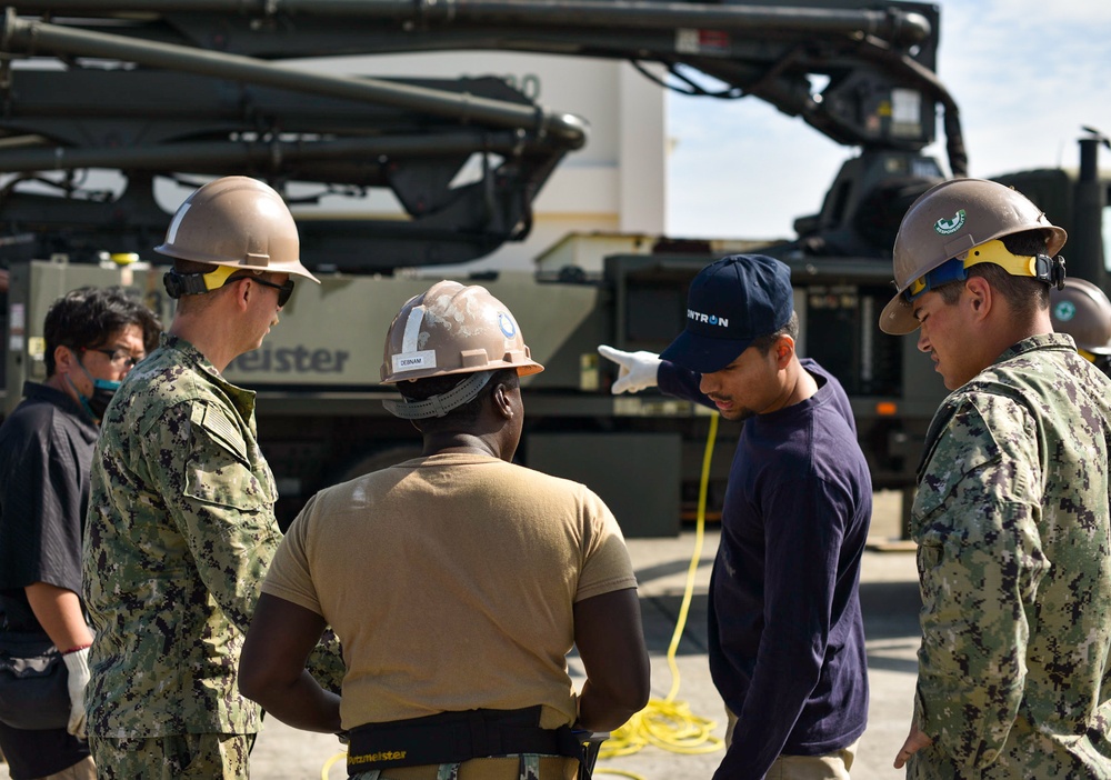 Seabees with Naval Mobile Construction Battalion Four receives  training on the high pressure and large capacity piston concrete pump.