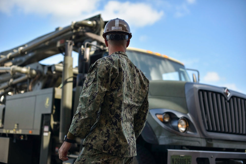 Seabees with Naval Mobile Construction Battalion Four receives  training on the high pressure and large capacity piston concrete pump.