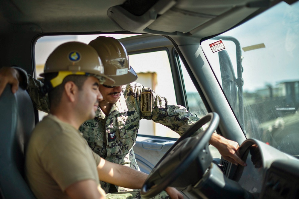 Seabees with Naval Mobile Construction Battalion Four receives  training on the high pressure and large capacity piston concrete pump.