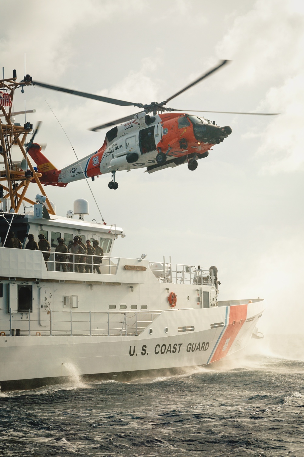 Coast Guard air and surface assets conduct a vertical insertion evolution