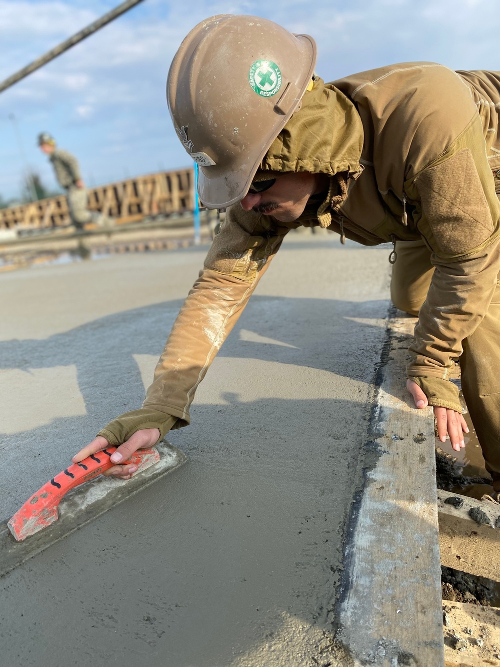 NMCB 11 Seabees and Georgian Engineers place concrete