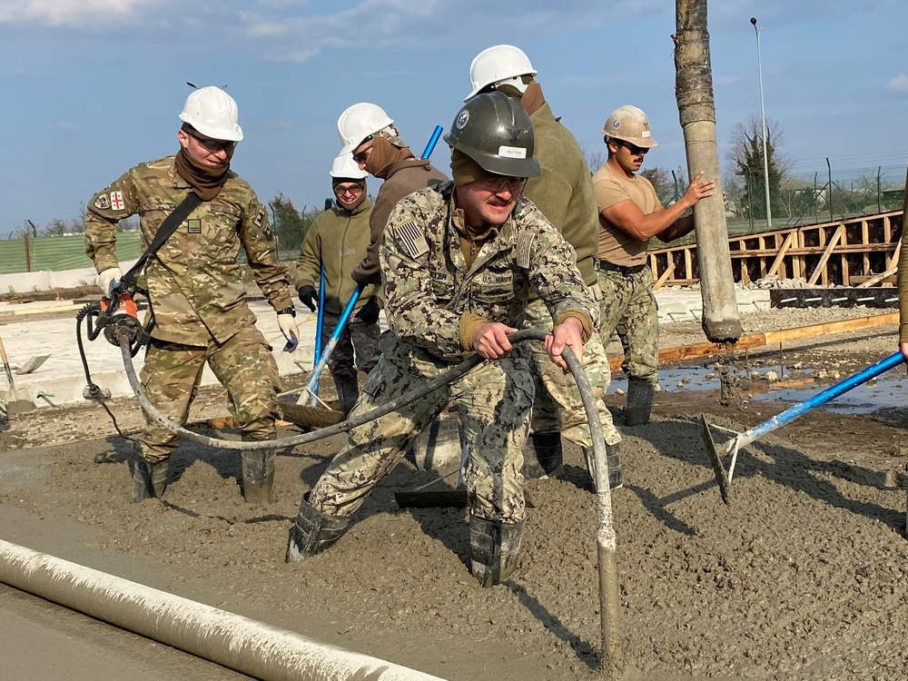 NMCB 11 Seabees and Georgian Engineers place concrete