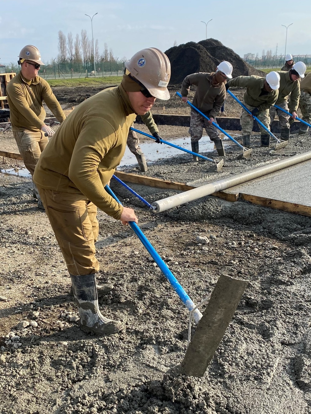 NMCB 11 Seabees and Georgian Engineers place concrete