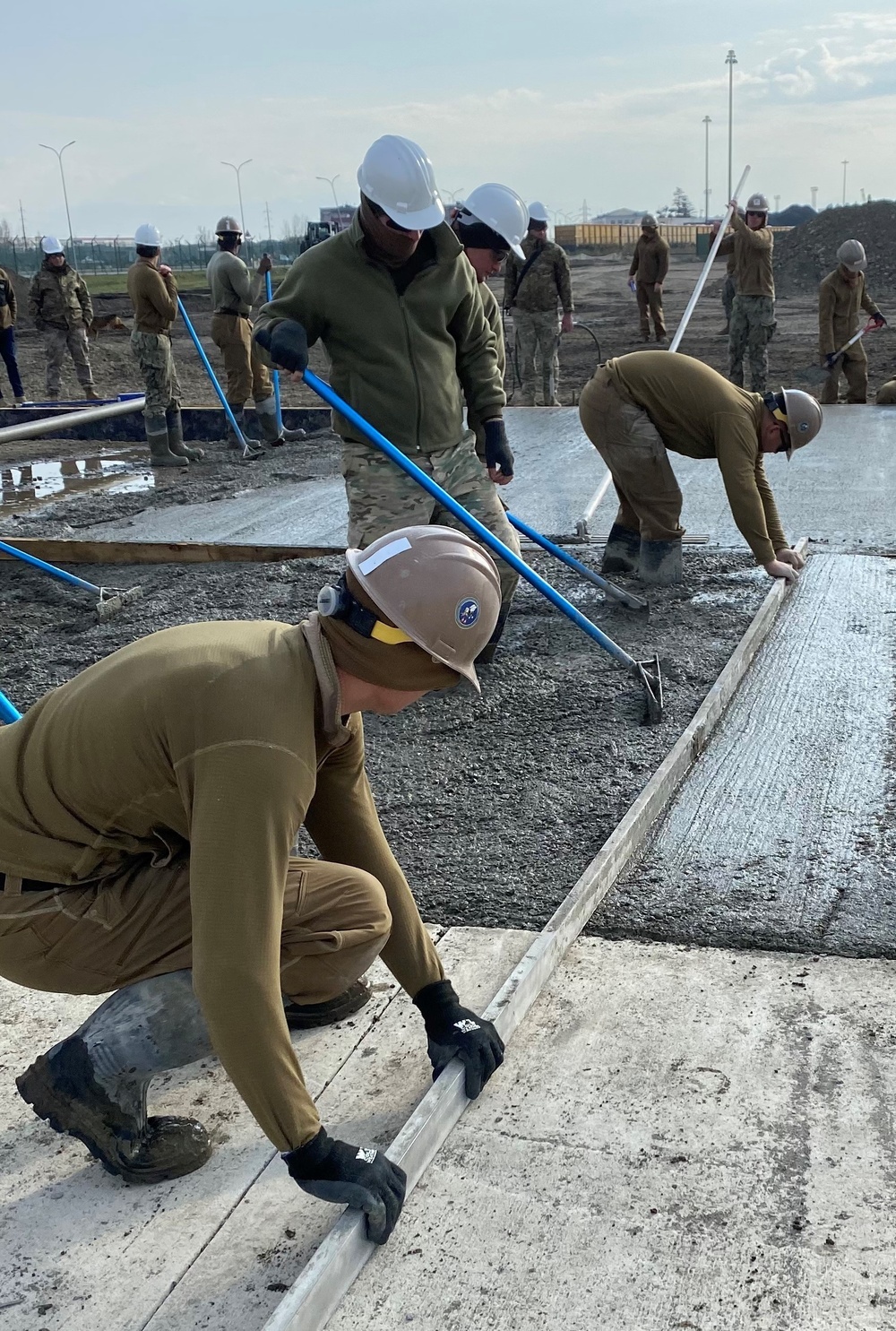 NMCB 11 Seabees and Georgian Engineers place concrete