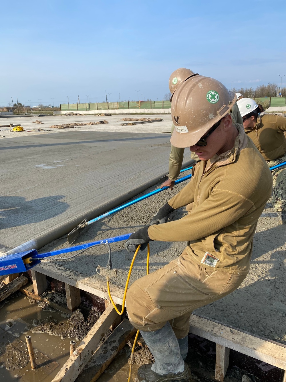 NMCB 11 Seabees and Georgian Engineers place concrete