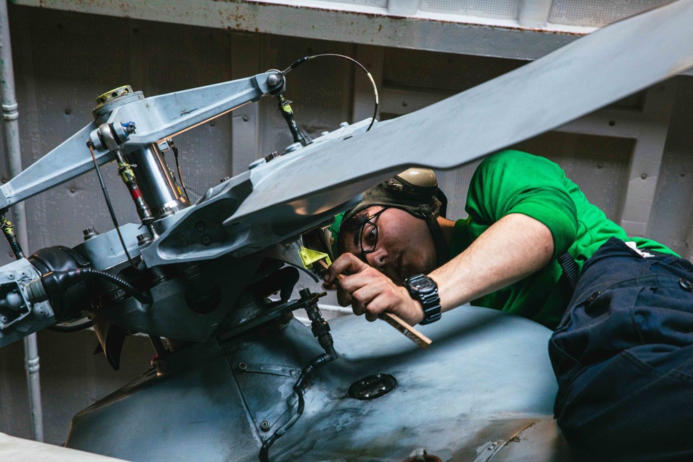 Sailor Performs Maintenance on Helicopter Blade