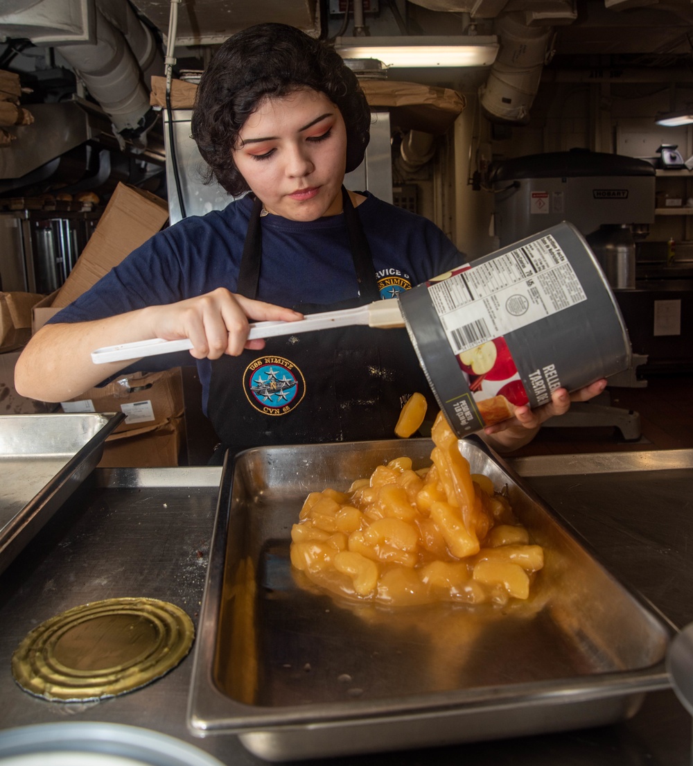 Sailor Transfers Canned Apples Into Tray