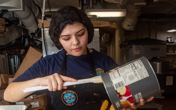 Sailor Transfers Canned Apples Into Tray