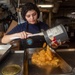 Sailor Transfers Canned Apples Into Tray