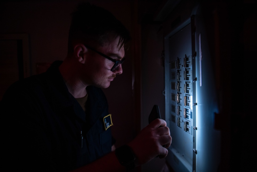 U.S. Navy Sailor Tags Out A Breaker Switch