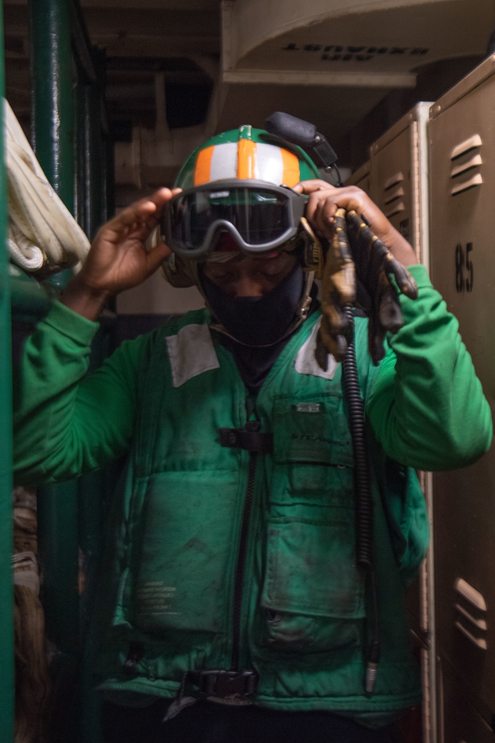 U.S. Navy Sailor Dons Flight Deck Gear