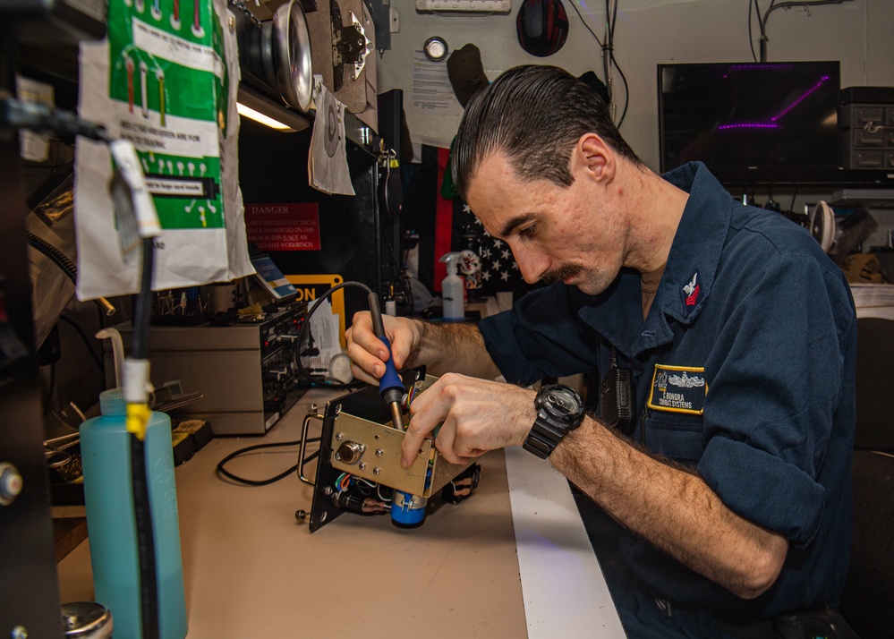 Sailor Performs Maintenance On A Sound Powered Amplifier