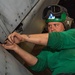 Sailor Installs A Panel On An Aircraft