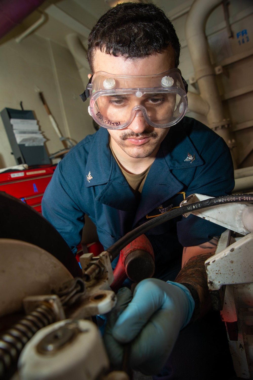 Sailor Removes Pin From Munitions Handling Unit