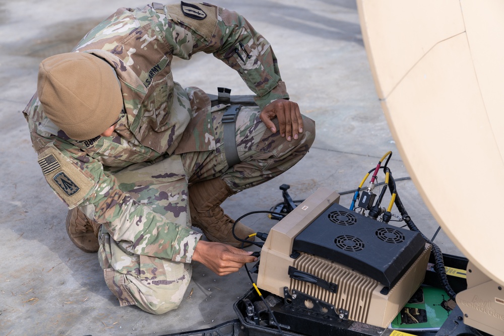 Charlie Company, 304th Expeditionary Signal Battalion soldiers assembling and maintaining signal equipment.