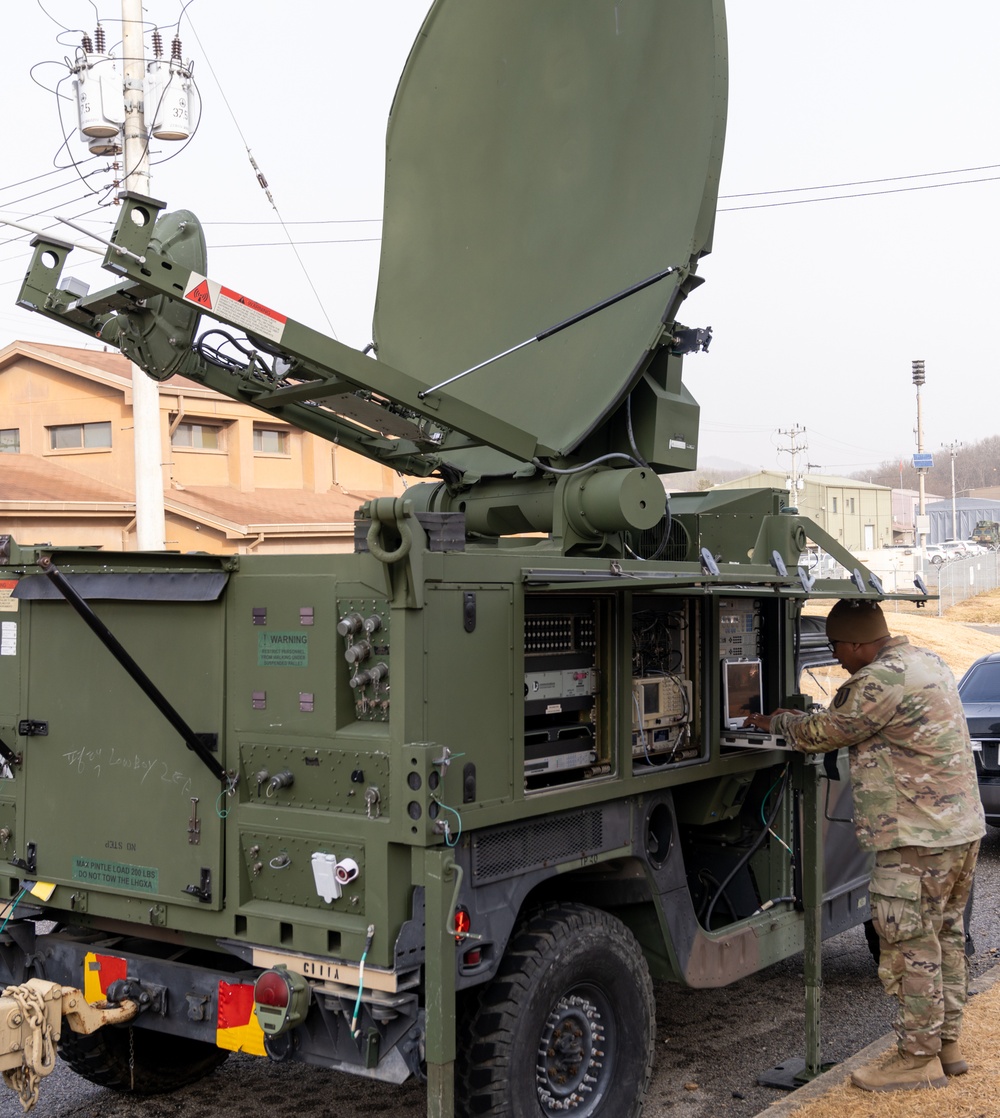 Charlie Company, 304th Expeditionary Signal Battalion soldiers assembling and maintaining signal equipment.