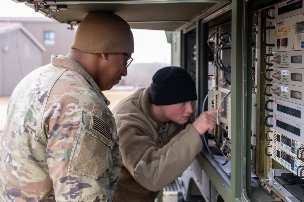 Charlie Company, 304th Expeditionary Signal Battalion soldiers assembling and maintaining signal equipment.