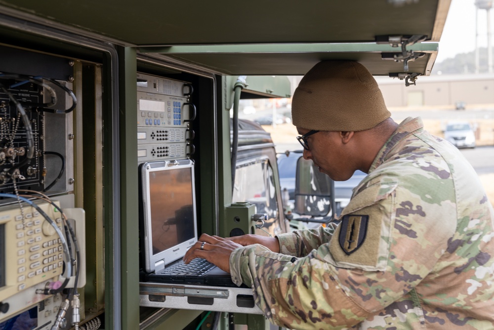 Charlie Company, 304th Expeditionary Signal Battalion soldiers assembling and maintaining signal equipment.