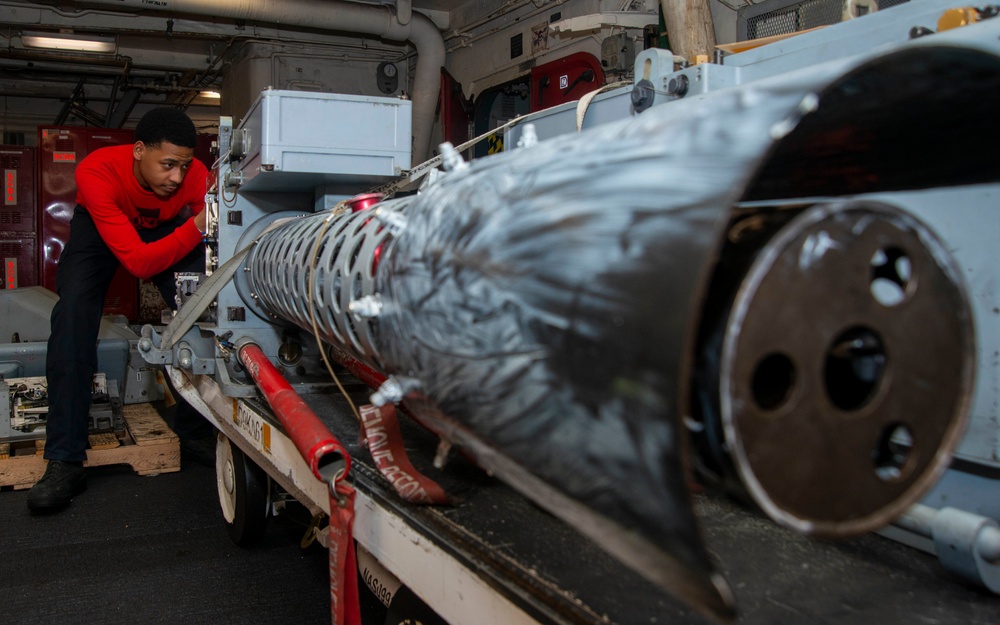 Sailor Removes Bolts From Gun System