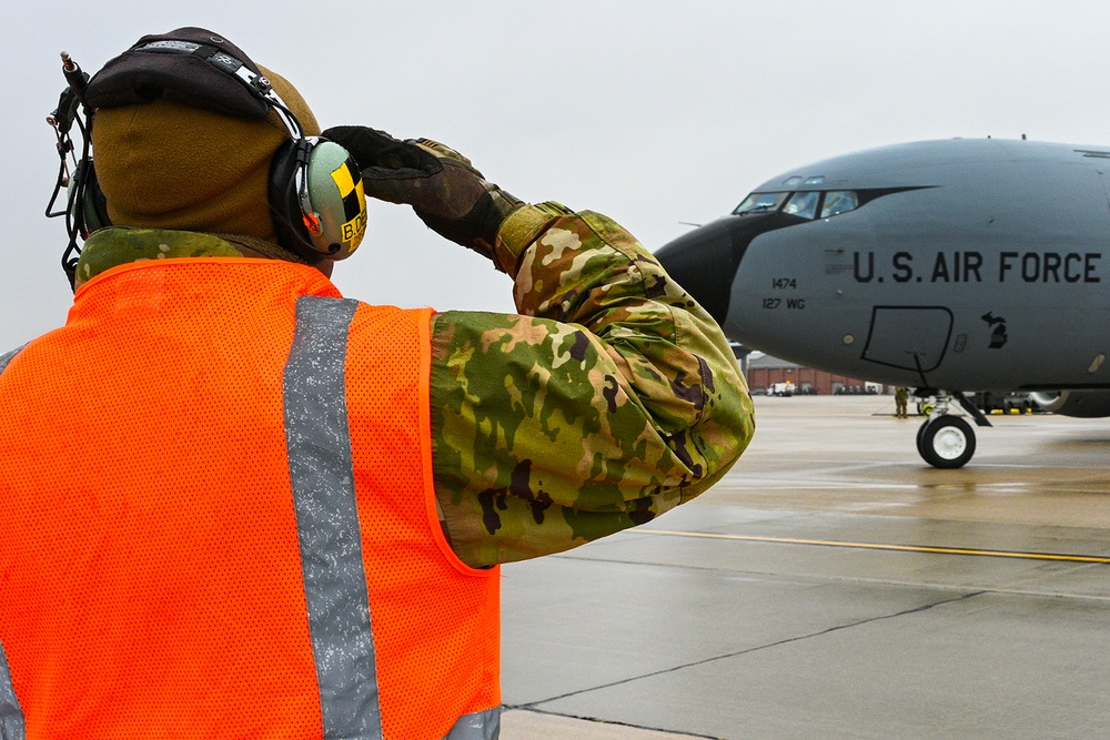 Crew Chief From the 191st AMXS Marshals to the Flight Line a KC-135