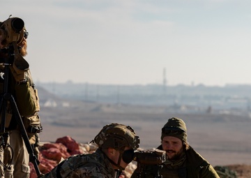 Members of Combined Joint Task Force - Operation Inherent Resolve share observation equipment
