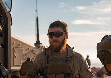 Members of Combined Joint Task Force - Operation Inherent Resolve share observation equipment