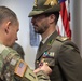 Commanding General Maj. Gen. Todd R. Wasmund presents Italian army Maj. Marco Nardi with the Meritorious Service Medal