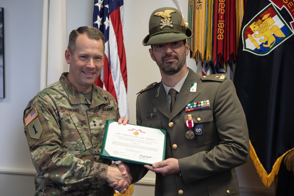 Commanding General Maj. Gen. Todd R. Wasmund presents Italian army Maj. Marco Nardi with the Meritorious Service Medal