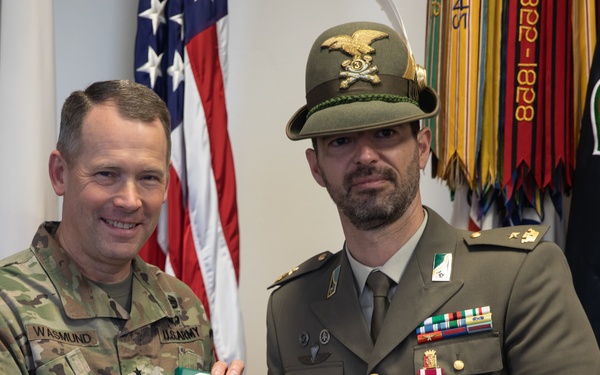 Commanding General Maj. Gen. Todd R. Wasmund presents Italian army Maj. Marco Nardi with the Meritorious Service Medal