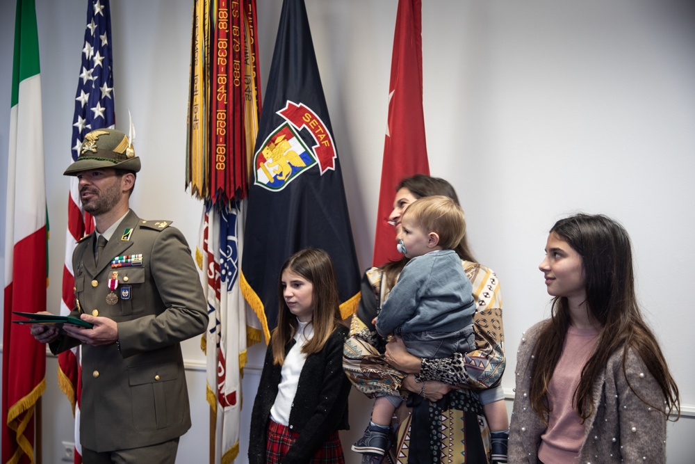 Commanding GeneralMaj. Gen. Todd R. Wasmund presents Italian army Maj. Marco Nardi with theMeritorious Service Medal