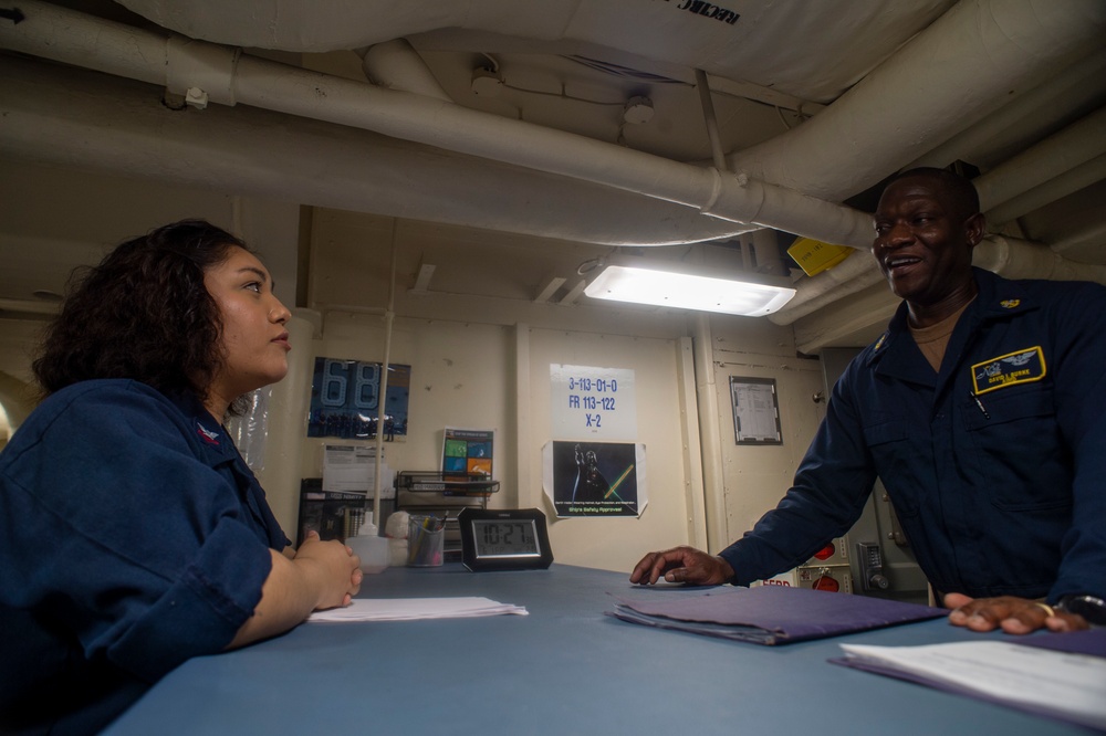 U.S. Navy Sailor Helps Navy Chief File Transfer Paperwork