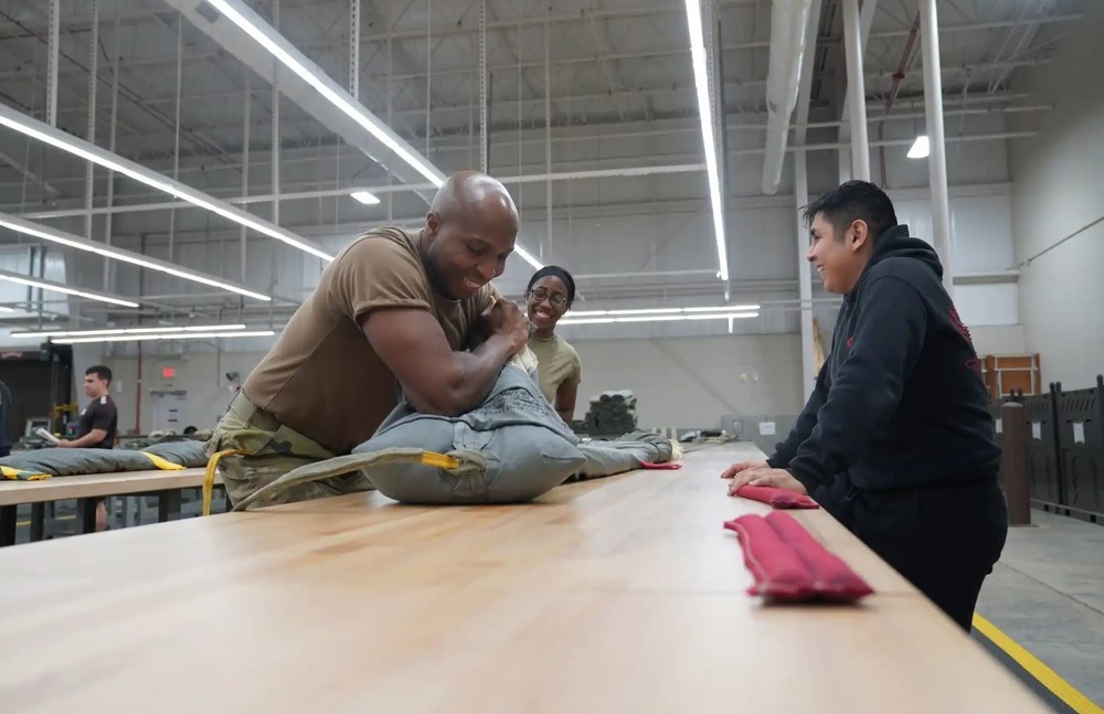 528th Special Troops Battalion and HHC Command Team learn how to pack chutes