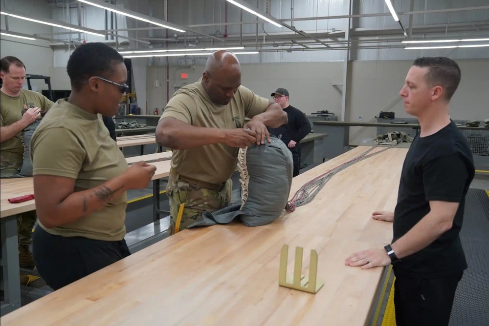 528th Special Troops Battalion and HHC Command Team learn how to pack chutes