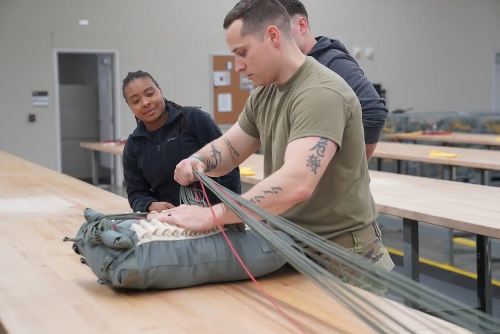 528th Special Troops Battalion and HHC Command Team learn how to pack chutes