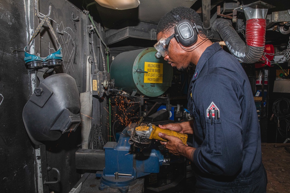 U.S. Sailor Grinds Metal