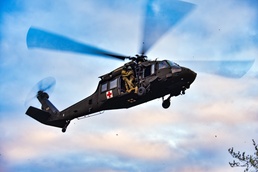 Tennessee National Guard Blackhawk hovers for medics to descend in joint exercise